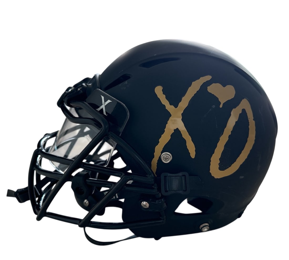 The Weeknd's Wardrobe - XO Xenith Football Helmet: XO Xenith Football Helmet, Certified Model, Initial Season 2017. XO is The Weeknd's own label and lifestyle imprint, released through Republic Records. SIZE: Large CONDITION: Pre-owned. The photograph
