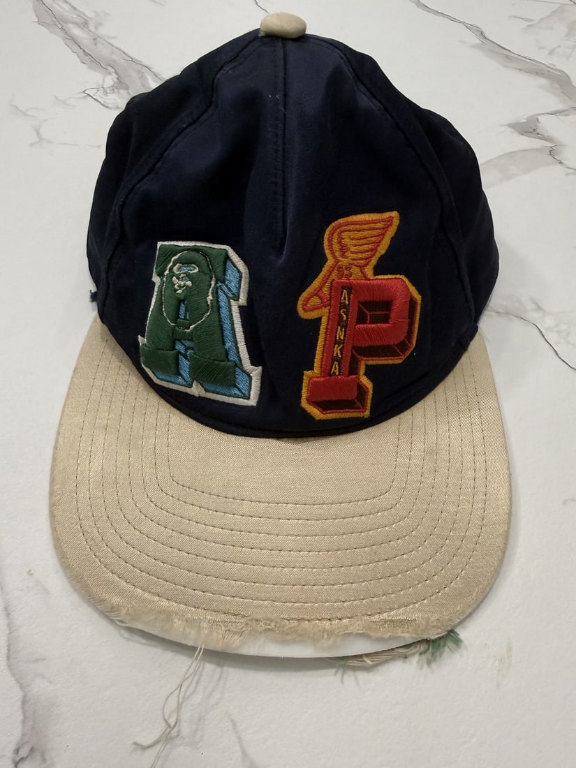 The Weeknd's Wardrobe - A Bathing Ape cap: A Bathing Ape Cap. CONDITION: Pre-owned. The photographs are part of this description - please review them carefully to assess condition. PROVENANCE: From the personal collection of Abel Makkonen Tesf