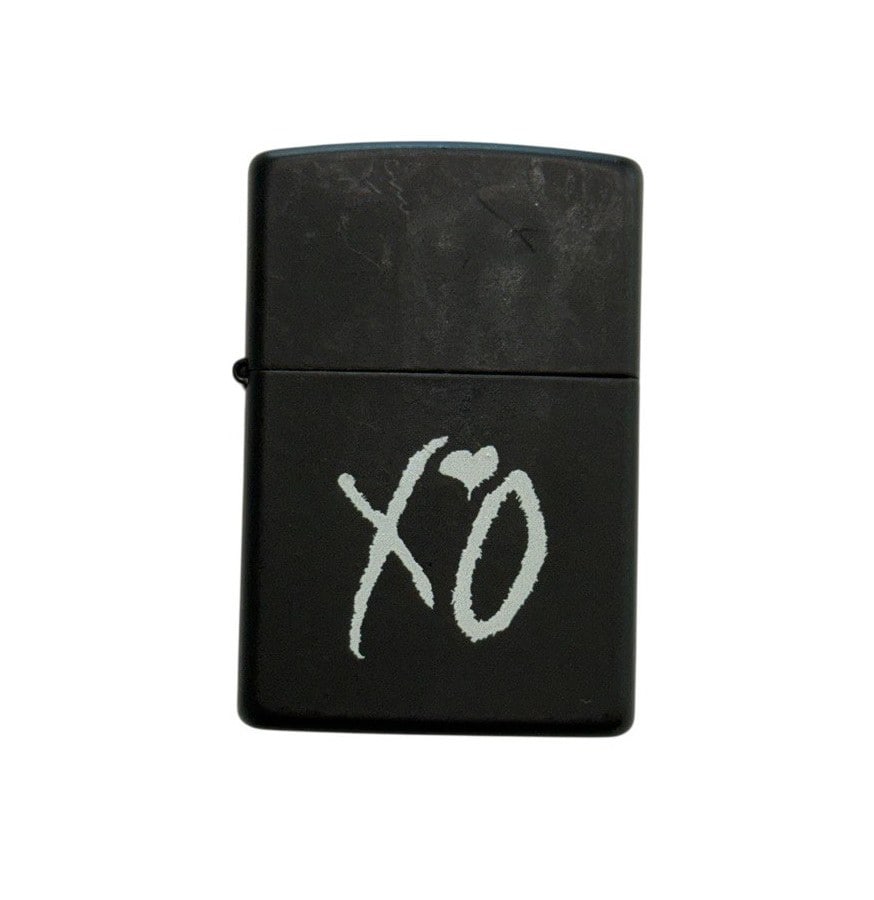 The Weeknd's Wardrobe - XO lighter: The Weeknd XO Lighter. XO is The Weeknd's own label and lifestyle imprint, released through Republic Records. CONDITION: Pre-owned. The photographs are part of this description - please review them ca