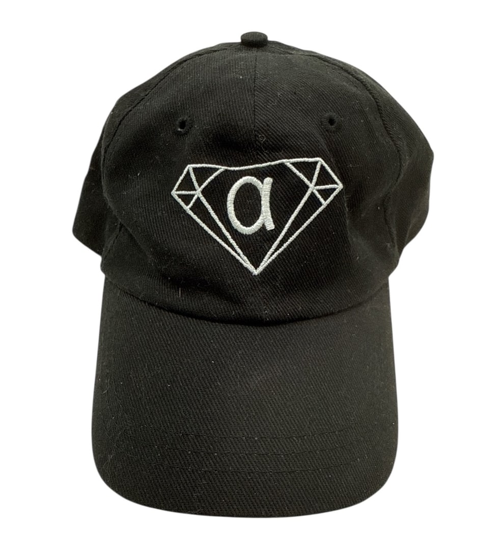 The Weeknd's Wardrobe - Alpha Jewelers St. Thomas Cap: Alpha Jewelers St. Thomas Cap. CONDITION: Pre-owned. The photographs are part of this description - please review them carefully to assess condition. PROVENANCE: From the personal collection of Abel M