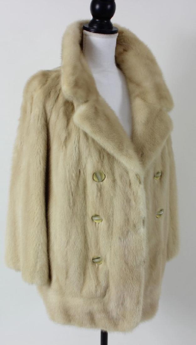 Mink Fur Coat: White fur mink coat, waist length, floral design on the inside of coat. Approximate measurements: Length: 28 inches Width: 20 inches. See Photos.