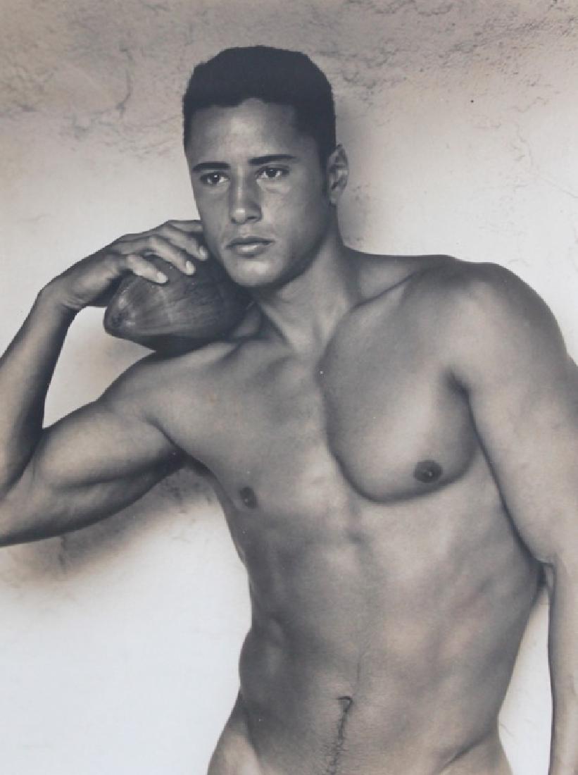 BRUCE WEBER (AMERICAN, B. 1946) PHOTOGRAPHY: BRUCE WEBER (AMERICAN, B. 1946) PHOTOGRAPHY. Nude Male. Holding Football. Measures 12 inches high x 8 3/4 inches wide + 1 7/8 inch frame.
