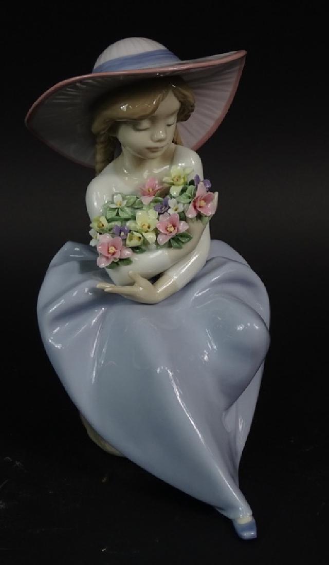 LLADRO ''FRAGRANT BOUQUET'' FIGURINE #5862: LLADRO ''FRAGRANT BOUQUET'' 1992 PORCELAIN LADY W/FLOWERS FIGURINE #5862. A little girl in a large hat cradling a large bunch of flowers. Hand crafted in Spain. Excellent Condition. Measures: 8.5 inch