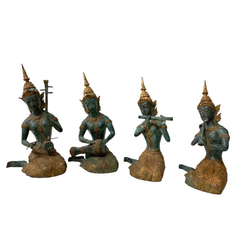Collection of 4 Thaibetian Buddha's: Collection of 4 Thaibetian Buddha's each playing a musical instrument. 3 Buddha's playing the flute and 1 Buddha is playing the drums. Each measures 11 inches high x 4 inches wide x 4 inches deep