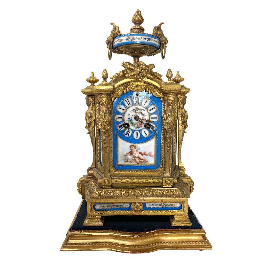 French Antique Bronze Clock, Sevres Blue Porcelain: French P. H. Mourey Sevres Clock . French Antique Bronze Clock, Sevres Blue Porcelain Clock. With Key clock and pendulum. Measures 14 inches high x 9 inches wide x 5 inches deep. Sir John Bennett Ltd.
