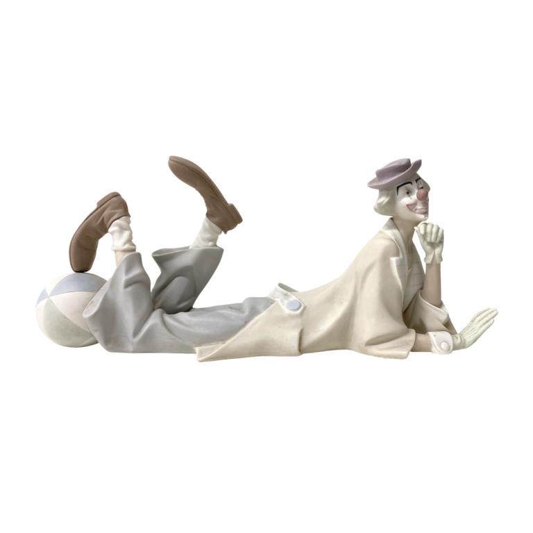 Lladro Porcelain Clown: Lladro Porcelain Clown. Hand decorated and made in Spain. Total Measurements 6 1/2 Inches High X 15 Inches Wide X 5 Inches Deep