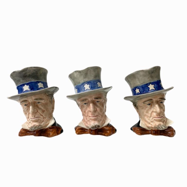 (3) Uncle Sam Character Royal Winton Jugs: (3) Uncle Sam Character Royal Winton Jugs Total Measurements 5 Inches High X 31/2 Inches Wide X 5 Inches Deep. Each vary in size. Graduating in Size