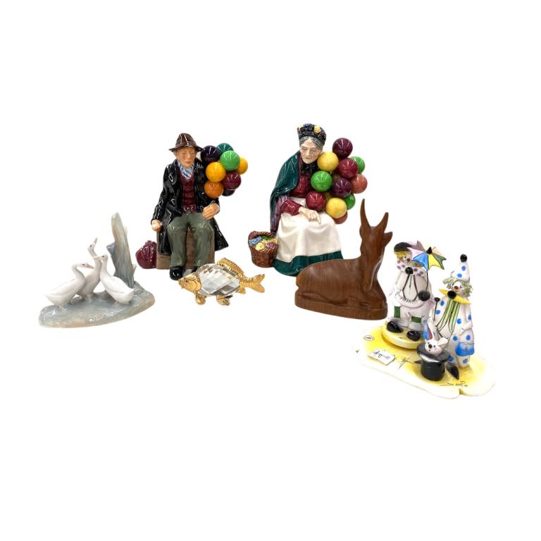 Collection of Royal Doulton Figurines: Collection of Royal Doulton Figurines and Miscellaneous Items. Items include 2 porcelain figurines of a man and woman holding balloons, small clown figures, a wooden donkey, a crystal fish, and a porc