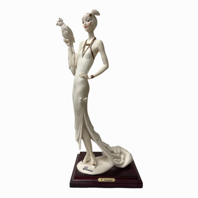 Guiseppe Armani "Lady With Parrot" Figurine: Guiseppe Armani "Lady With Parrot" Figurine. Signed. Florence. 1987. Made in Italy. Measures 13 inches high x 4 inches in diameter.