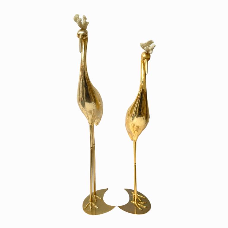 Pair of Vintage Brass Egrets W/ White Coral Plumes: A pair of vintage brass sculptures depicting egrets with natural white coral plumes. Largest measures approx. 35" height.