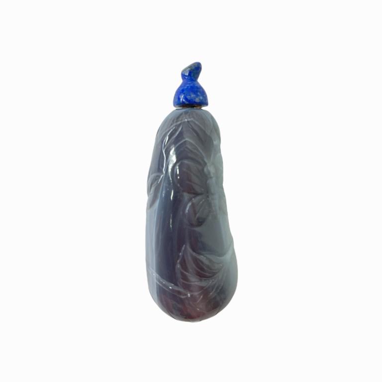 Chinese Carved Blue Agate Butterflies Snuff Bottle: Chinese carved snuff bottle of blue agate having a gourd form with raised butterflies and flowers design. Has a lapis lazuli snuffer. Measures approx. 3" length. Appears in overall good condition.