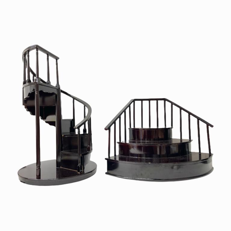 2 Byers Lacquered Wood Stair Curio Display Shelves: A lot of two lacquered wood staircase form curio display riser shelves by Byers Choice Ltd. Largest measures approx. 22" height x 14" diameter. Some nicking seen to spiral shelf.