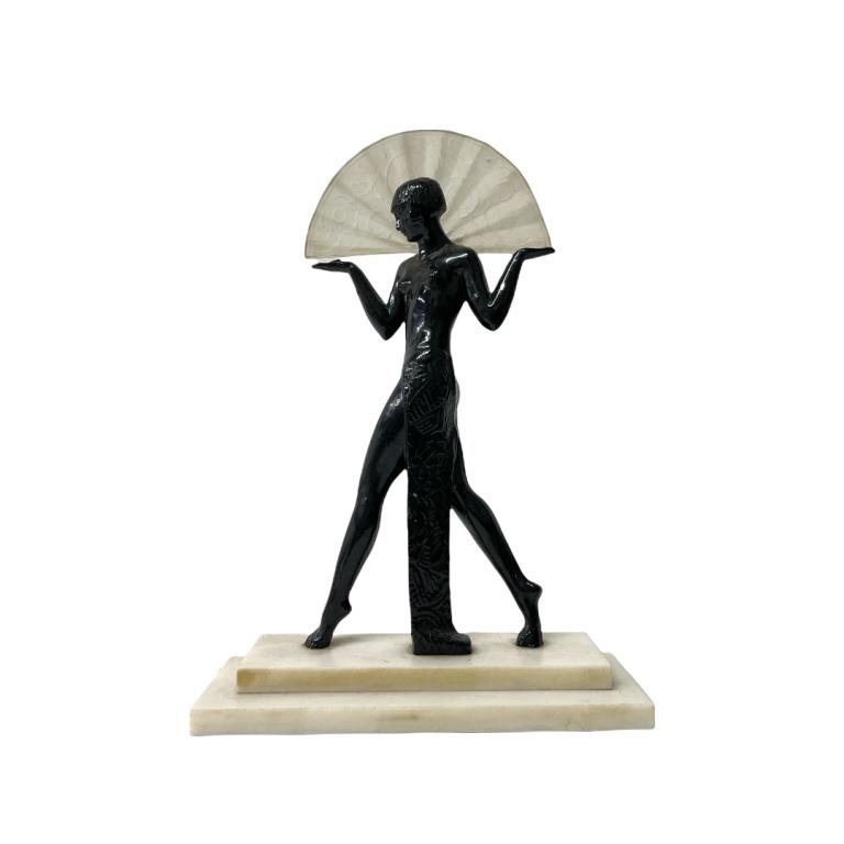 Art Deco Sarsparilla Egyptian Revival Table Lamp: Art Deco Sarsparilla Egyptian Revival table lamp crafted of black enameled cold painted metal depicting a dancing nude female with frosted crystal fan form shade atop a tiered white alabaster base. Me