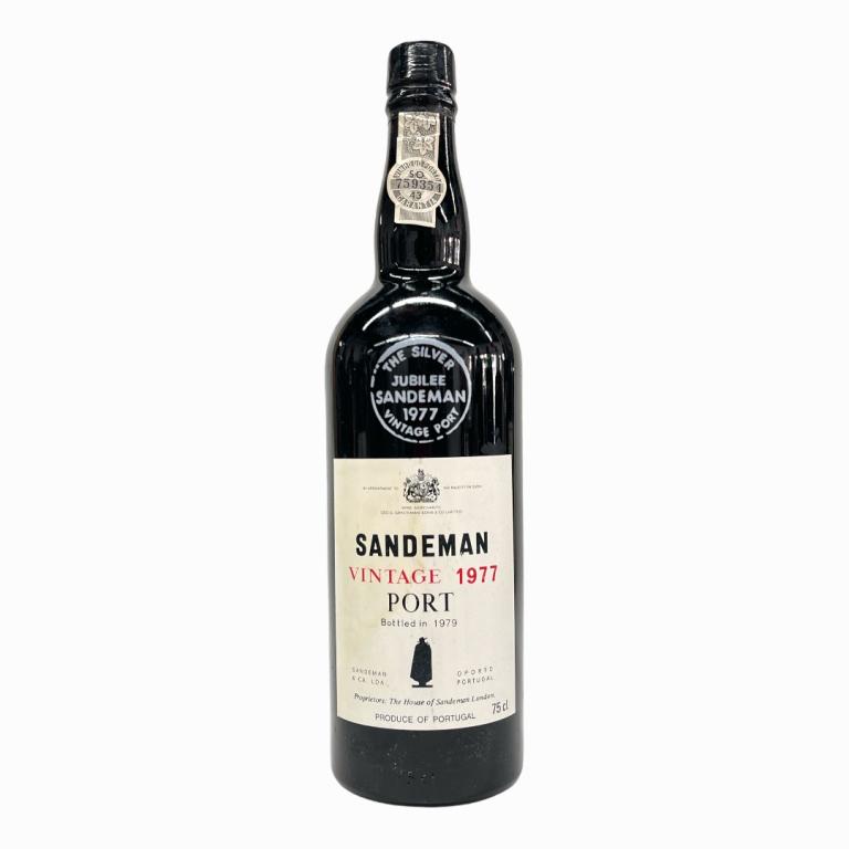1977 Sandeman Portuguese Vintage Port Wine: 1977 George G. Sandeman & Company Vintage Portuguese Port Wine. Approx. 700 to 750mL? Sealed and kept in cellar. Some wear to labels and loss to paper seal.