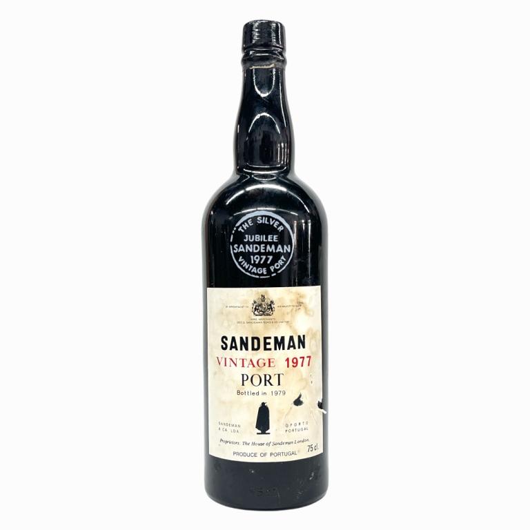 1977 Sandeman Portuguese Vintage Port Wine: 1977 George G. Sandeman & Company Vintage Portuguese Port Wine. Approx. 700 to 750mL? Sealed and kept in cellar. Some wear to labels and loss to paper seal.