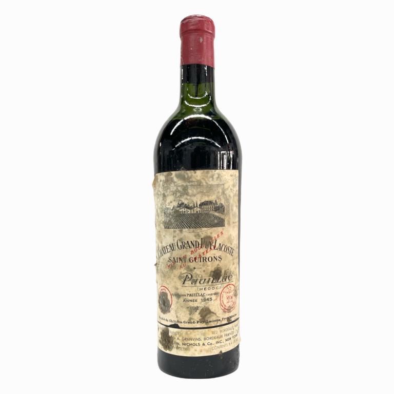 1945 Chateau Grand-Puy-Lacoste Pauillac Wine: 1945 French Chateau Grand-Puy-Lacoste Pauillac table wine in 750mL bottle. Sealed and kept in cellar. Some wear to labels. Has Sotheby's label to side.