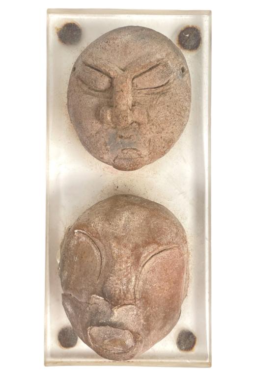 A lot of 2 ancient Olmec culture Pre-Colombian clay face sculptures mounted on a clear acrylic: A lot of 2 ancient Olmec culture Pre-Colombian clay face sculptures mounted on a clear acrylic display base. Found in the La Venta pre-Colombian Archaeological area. Measures approx. 5" length x 2 3/8
