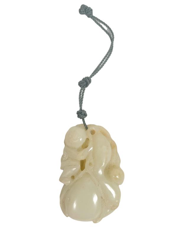 What appears to be an antique Chinese Qing Dynasty period toggle pendant carved from a pebble of: What appears to be an antique Chinese Qing Dynasty period toggle pendant carved from a pebble of what appears to be white Hetian / Hotan mutton fat jade. Or possibly white nephrite? The pendant depict