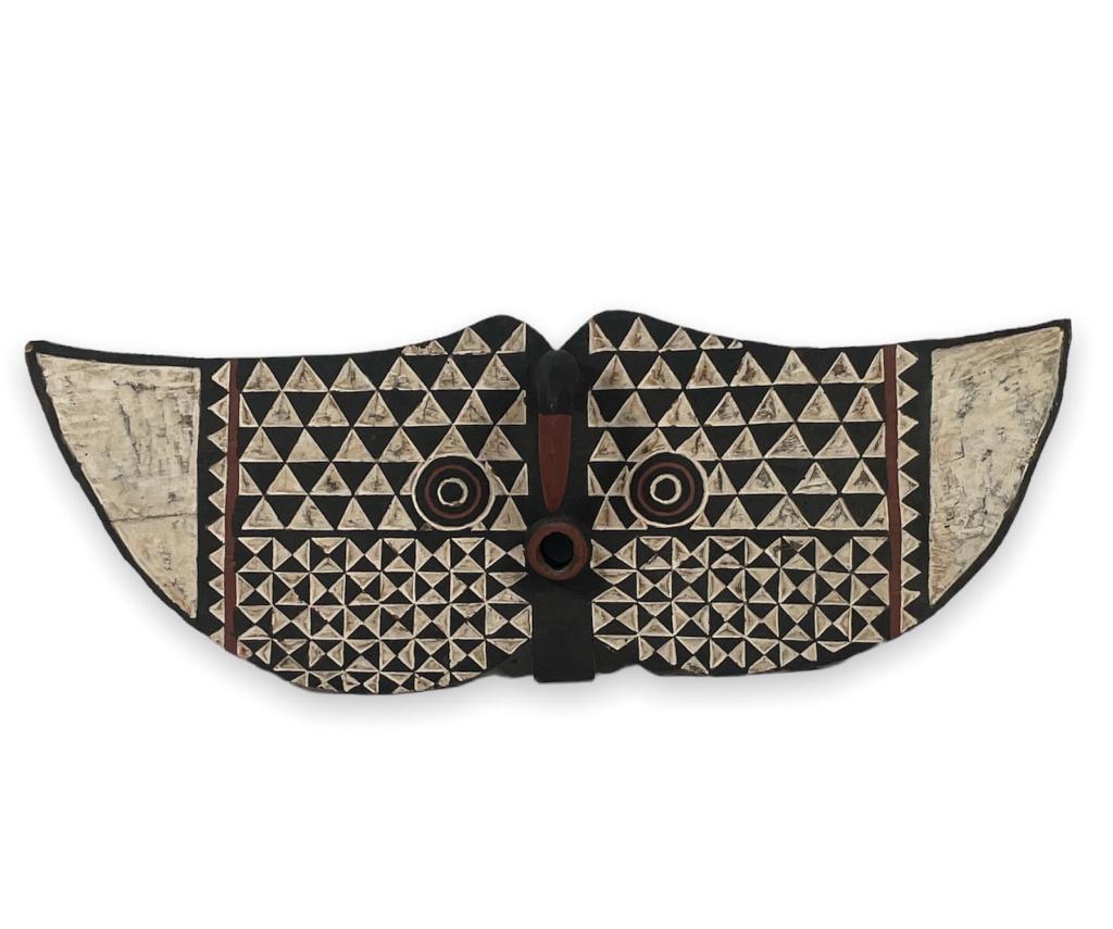 Large and impressive vintage African tribal carved wooden ceremonial mask having a bird design with: Large and impressive vintage African tribal carved wooden ceremonial mask having a bird design with recessed geometric patterns to front and back. Measures approx. 19 1/2" height x 51" width. Beak app