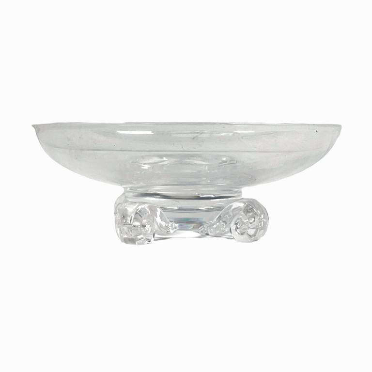 Steuben clear glass round cenerpiece bowl having four scrolled feet. Signed to bottom. Measures (1 of 3)