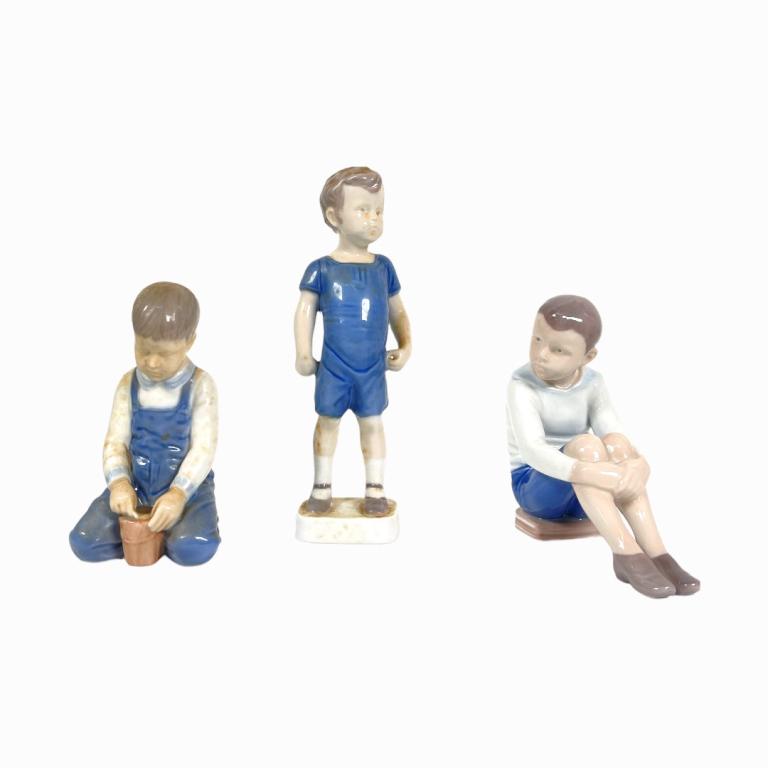 A lot of three Bing & Grondahl Copenhagen Denmark porcelain sculptures depicting young boys. Tallest: A lot of three Bing & Grondahl Copenhagen Denmark porcelain sculptures depicting young boys. Tallest measures approx. 8" height. Appear in overall good condition.
