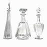 A lot of three Baccarat French clear crystal decanters with stoppers. Each with round acid marks to