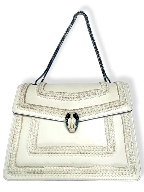 Bvlgari Serpenti Leather Handbag: Crafted from calf leather with a varnished and pearled effect, this crossbody features black plated brass hardware, alluring snakehead closure, double compartment and a gold-plated chain crossbody str