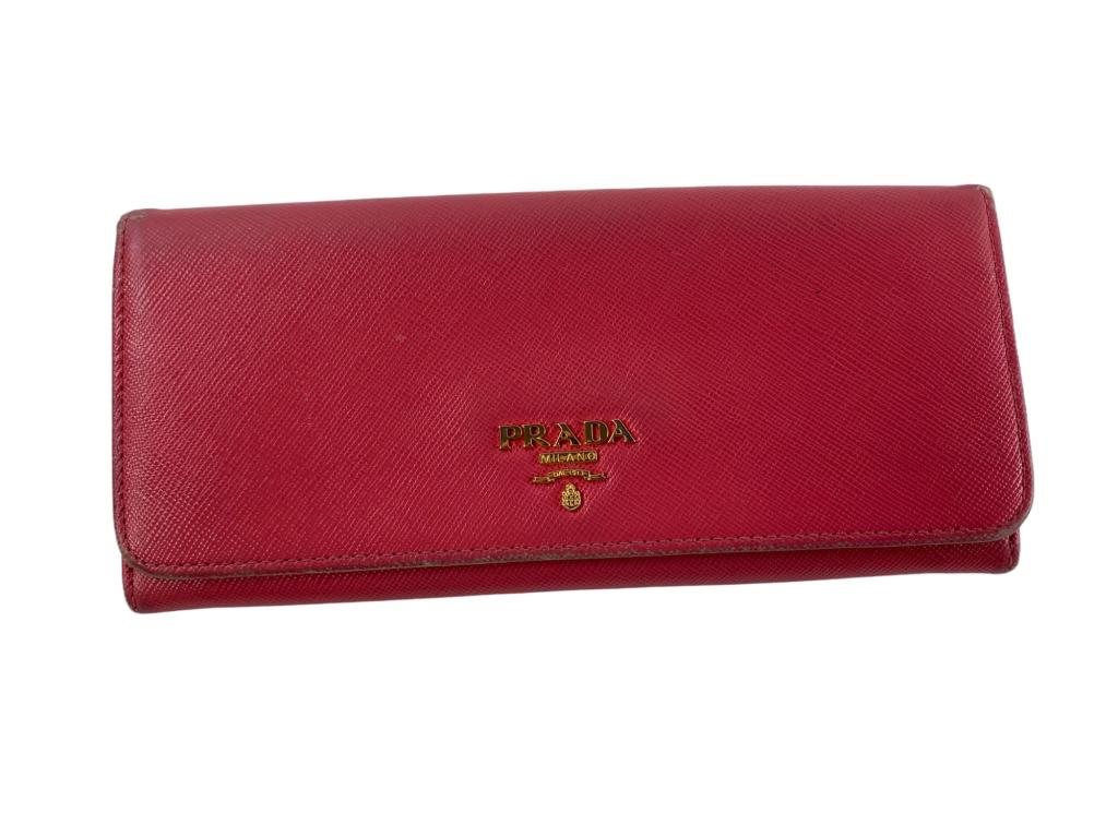 Prada Pink Saffiano Wallet With Card: #: 162 Item:Prada Pink Saffiano Wallet With Card Designer:PRADA Condition:C Color:Pink Hardware Color:Gold Material:Leather Accesories:N/A Serial Number:N/A Strap Drop / Handle Length/Waist:N/A Weight