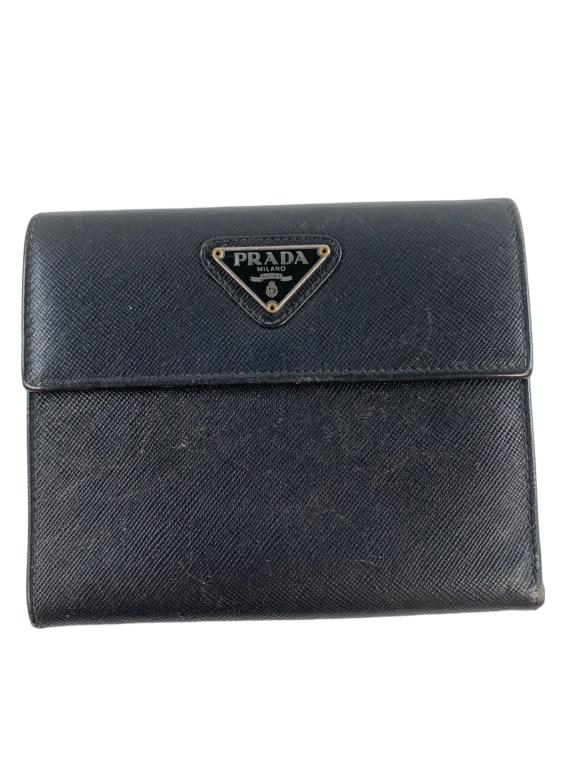 Prada Black Saffino Folding Wallet: #: 166 Item: Prada Black Saffino Folding Wallet Designer:PRADA Condition:C Color:Black Hardware Color:Silver Material:Leather Accesories:N/A Serial Number:N/A Strap Drop / Handle Length/Waist:N/A Weig