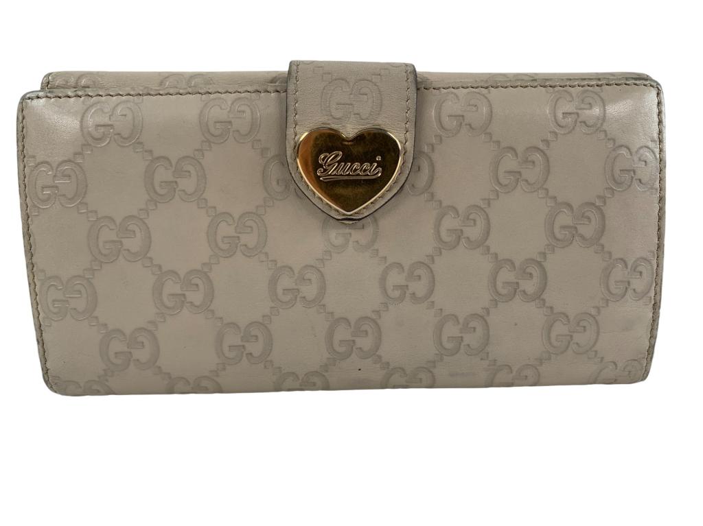 Gucci Gucchishima Long Wallet: #:201 Item:Gucci Gucchishima Long Wallet Designer:Gucci Condition:C Color:White Hardware Color:Gold Material:Leather Accesories:N/A Serial Number:N/A Strap Drop / Handle Length/Waist:N/A Weight (lbs):