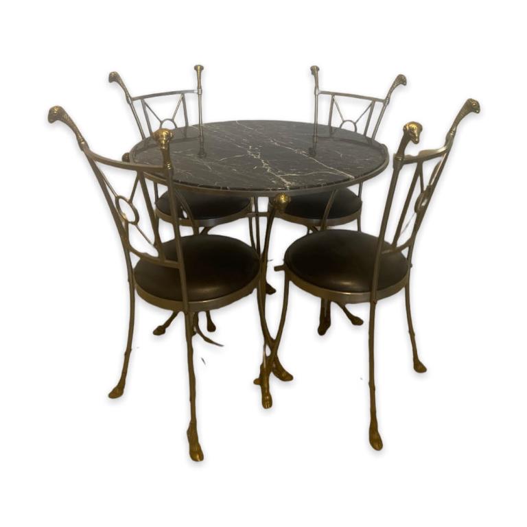 Maison Jansen Style Regency Goat Table & Chairs: Maison Jansen French style Mid Century Modern Hollywood Regency round table crafted of steel and gilt brass having figural goat head and hoof design completed with black marble top. Table is accompani