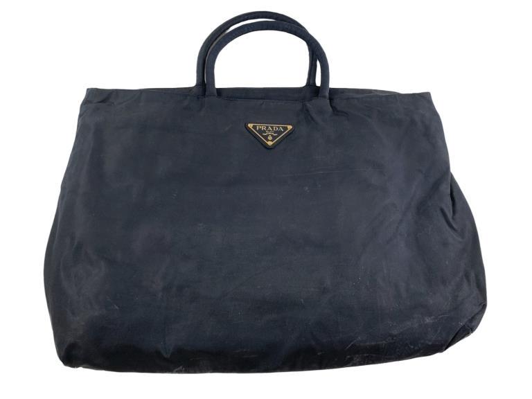 Prada Navy Tote: #: 553 Item:Prada Navy Tote Designer:Prada Condition:B Color:Navy Hardware Color:Gold Material:Nylon Accesories:N/A Serial Number:N/A Strap Drop / Handle Length/Waist:6 Weight (lbs):1.15 Measurment:L