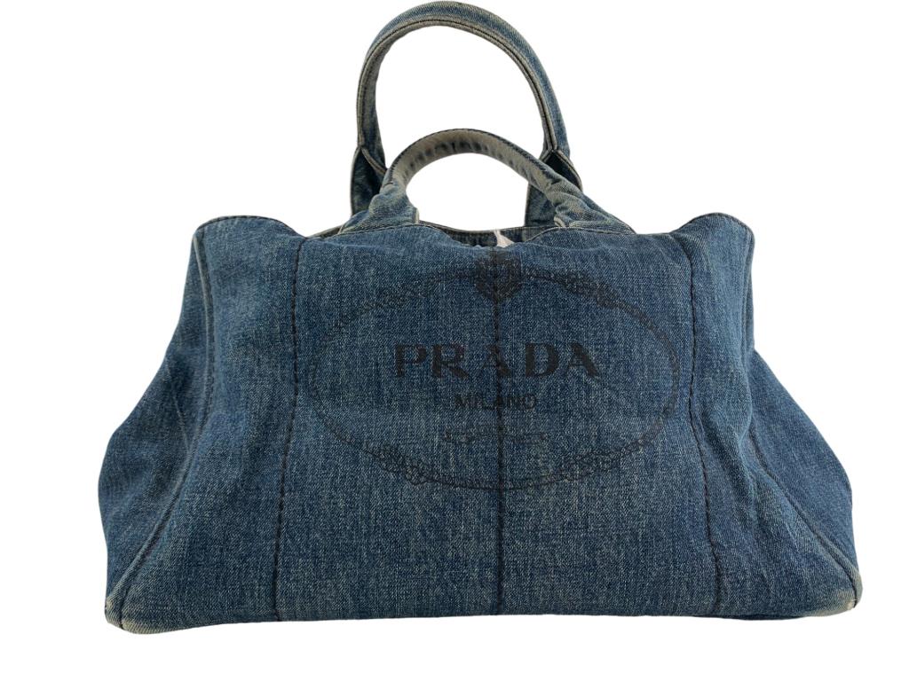 Prada Denim Canapa Tote: #: 788 Item:Prada Denim Canapa Tote Designer:PRADA Condition:BC Color:Blue Hardware Color:Gold Material:Denim Accesories:Dustbag Serial Number:N/A Strap Drop / Handle Length/Waist:HL: 7 Weight (lbs):2