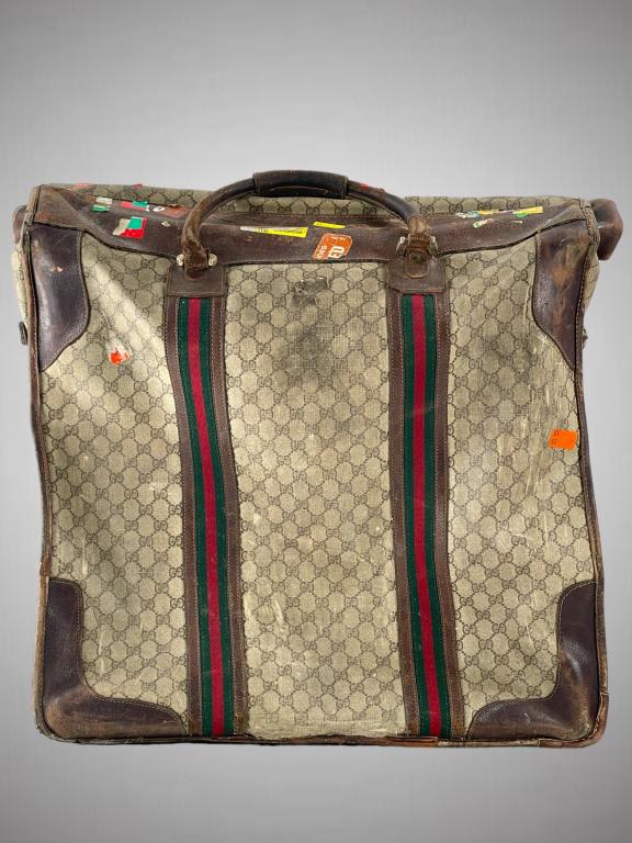 VINTAGE GUCCI MONOGRAM "FOLDING GARMENT LUGGAGE: VINTAGE GUCCI MONOGRAM "FOLDING GARMENT WEEKEND BAG LUGGAGE (1980'S) DIMENSIONS: 17 x 10 x 21 PLEASE SEE PHOTOS FOR CONDITION