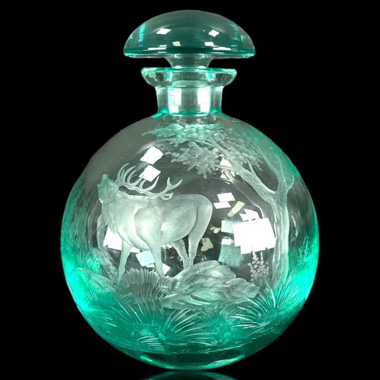 Moser Aqua Glass Etched Scenic Deer Decanter: A Moser Czech aqua glass decanter with stopper of globular form featuring an etched wilderness scene with a grunting buck. Acid hallmark to bottom. Stopper marked "28". Measures approx. 8" height incl
