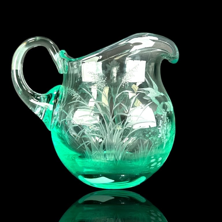 Moser Aqua Glass Etched Scenic Geese Pitcher: A Moser Czech aqua glass pitcher with applied handle featuring an etched wilderness meadow scene with flying geese. Acid hallmark to bottom. Measures approx. 7" height x 8" width x 6" depth. Typical s