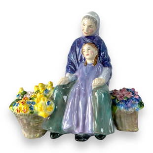 Royal Doulton "Granny's Heritage" Sculpture HN2031: Royal Doulton English porcelain sculpture depicting a grandmother and grand daughter with flower baskets titled "Granny's Heritage" number HN2031. Measures approx. 7" height x 7 1/2" width x 4 1/2" de