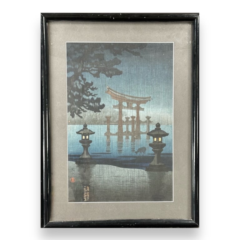 Tsuchiya Koitsu (Japanese, 1890 - 1949) original woodblock print on paper titled "Miyajima in the: Tsuchiya Koitsu (Japanese, 1890 - 1949) original woodblock print on paper titled "Miyajima in the Rain" depicting a deer near a shrine in water. Seal marks to lower left. Mounted in a black lacquer wo