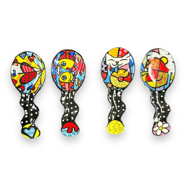 A lot of 4 Romero Britto ceramic spoon rests by Giftcraft. Includes "A New Day", "Apple", "Cat" and (1 of 4)