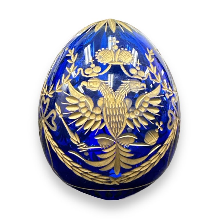 A vintage Faberge cut cobalt glass egg form decorative paperweight depicting Imperial double headed (1 of 3)