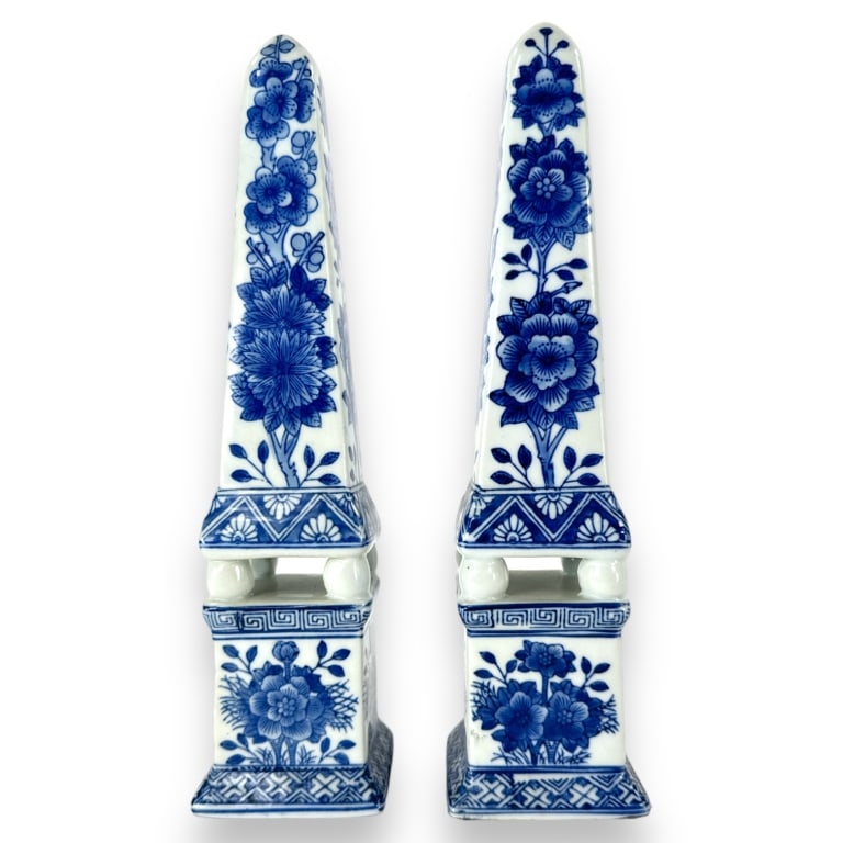 A pair of Chinese blue and white glazed porcelain obelisk phallic sculptures having a floral blooms: A pair of Chinese blue and white glazed porcelain obelisk phallic sculptures having a floral blooms design. No apparent hallmarks. Each measures approx. 12 1/2" height x 3 1/8" width x 3 1/8" depth. A