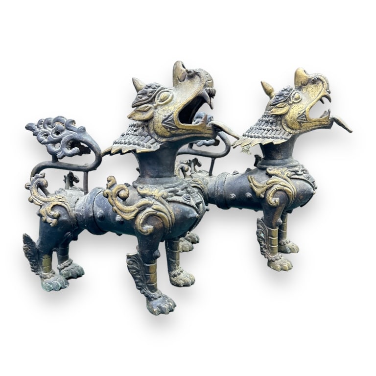 A pair of vintage, possibly antique?, Thai heavy parcel gilt bronze Kylin beast sculptures. Each: A pair of vintage, possibly antique?, Thai heavy parcel gilt bronze Kylin beast sculptures. Each with ornate scrolled designs. No apparent hallmarks. Each measures approx. 11" height x 11" length x 4 