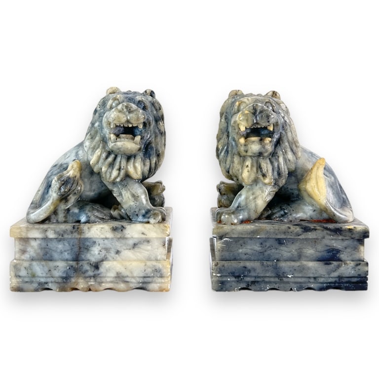 A pair of Chinese soap stone carved lion sculptures in gran and white. Each measures approx. 6" (1 of 3)