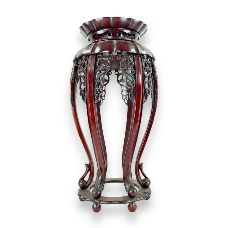 Chinese Dark wood six leg pedestal stand table having a lotus blossom form. Each leg flanked with (1 of 3)