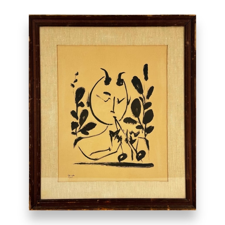 Pablo Picasso print depicting a Satyr with double horn. Signed in the plate to lower left. Mounted: Pablo Picasso print depicting a Satyr with double horn. Signed in the plate to lower left. Mounted in a wooden frame with mat behind glass screen. Paper measures approx. 15 1/4" height x 19 1/2 " widt