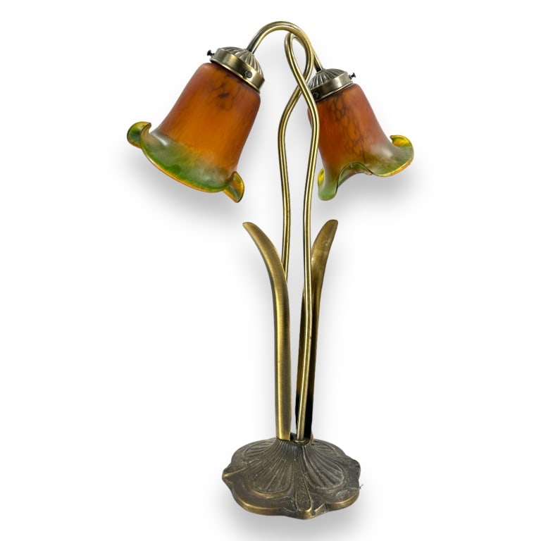 Art Nouveau style vintage art glass shade lamp. Has a metal base and gilt brass hardware. Measures: Art Nouveau style vintage art glass shade lamp. Has a metal base and gilt brass hardware. Measures approx. 21 1/2" height x 13 1/2" width x 6" depth. Appears in overall good condition. JD/B15/SH:15A