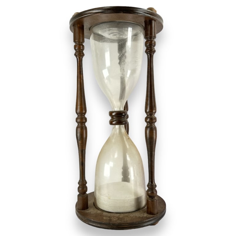 A vintage wooden case and glass hourglass with sand. Measures approx. 23 3/4" height x 11" diameter. (1 of 2)