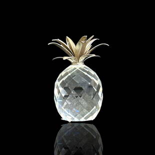 Swarovski faceted clear crystal figural pineapple fruit sculpture completed with white metal top.: Swarovski faceted clear crystal figural pineapple fruit sculpture completed with white metal top. Swan mark to bottom. Measures approx. 4" height x 3 1/4" diameter. Minor fleabites on edge of base. Ot