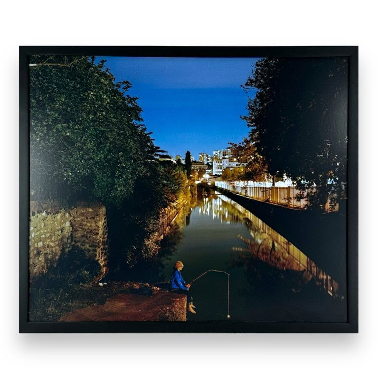 Kevin Cooley (USA B1975) Chromogenic Print Of Cana: Kevin Cooley (AMERICAN / LOS ANGELES, Born 1975) chromogenic print depicting a canal with fisherman. Probably signed and numbered to verso. Mounted in a black lacquer wooden frame. Paper measures appr
