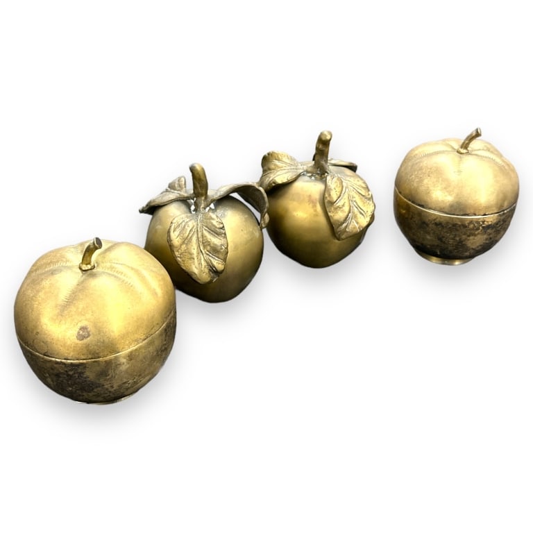 A lot of four vintage brass apple sculptures and boxes. Two depict apples with a face design and two (1 of 4)